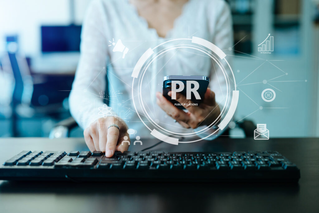 person typing at a keyboard with public relations
